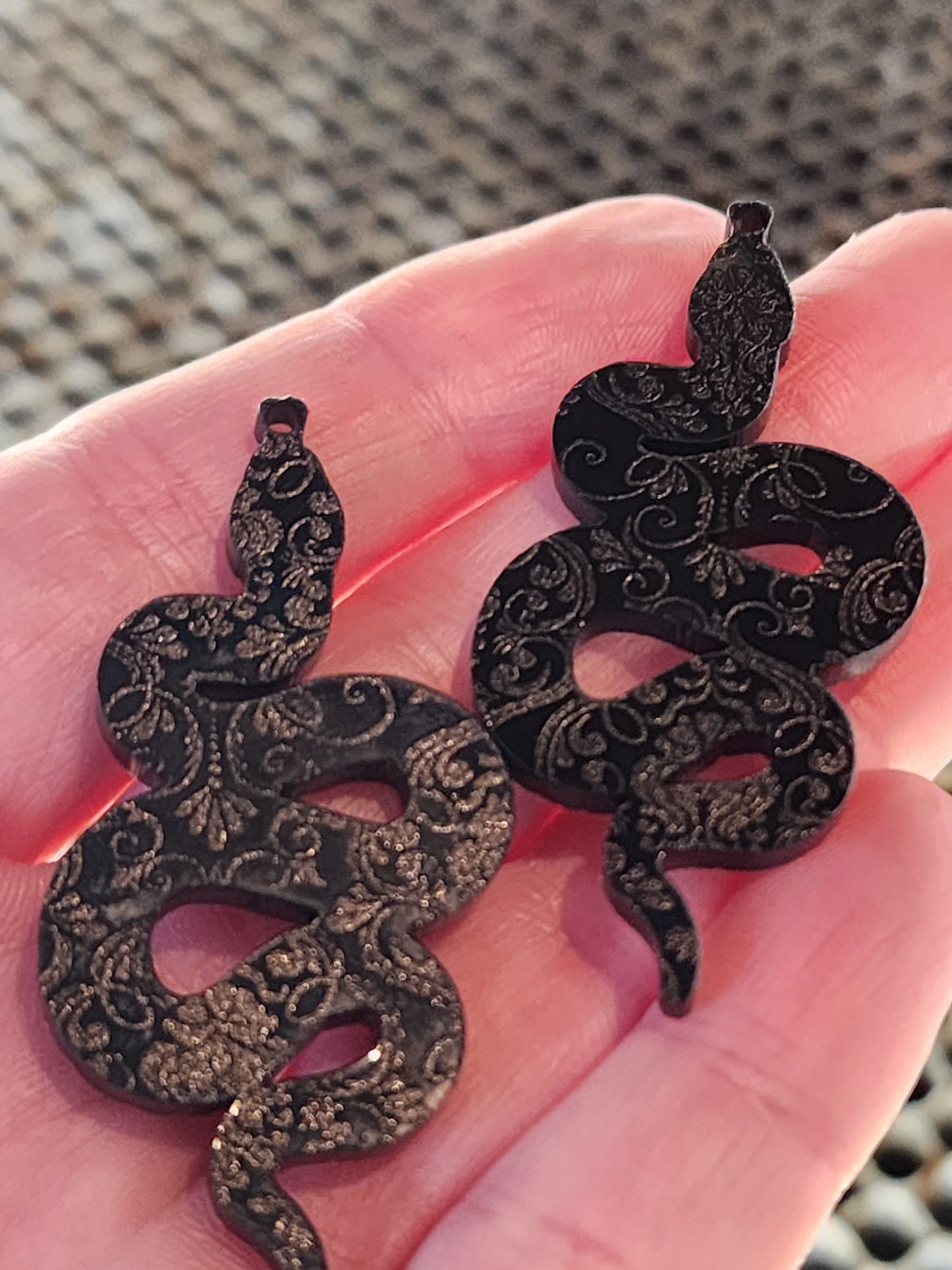 Black floral snake earrings