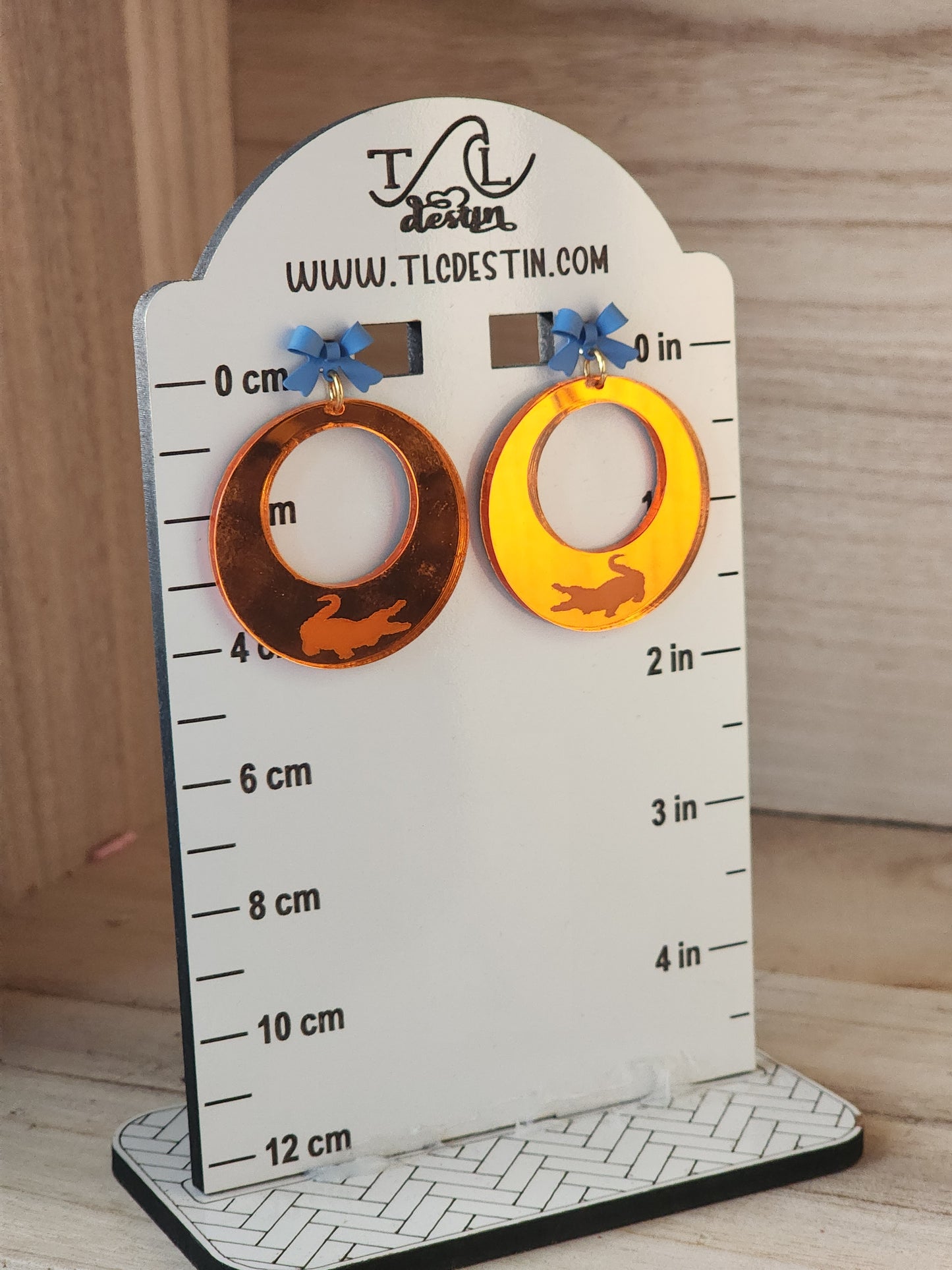 Orange mirrored Gator earrings.