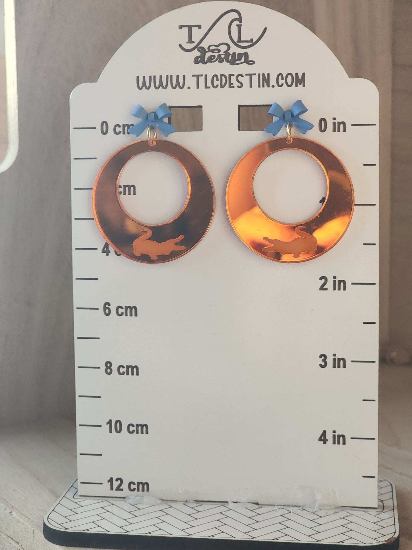 Orange mirrored Gator earrings.